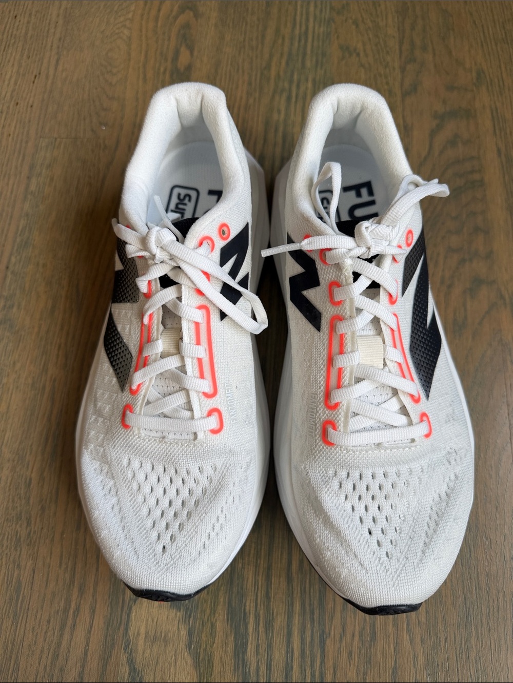 New Balance White Sneakers with Black Logos and Coral Eyelets